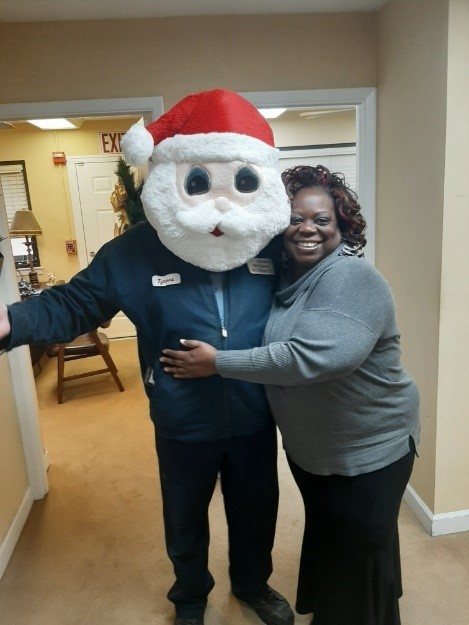 Santa hugged by staff member