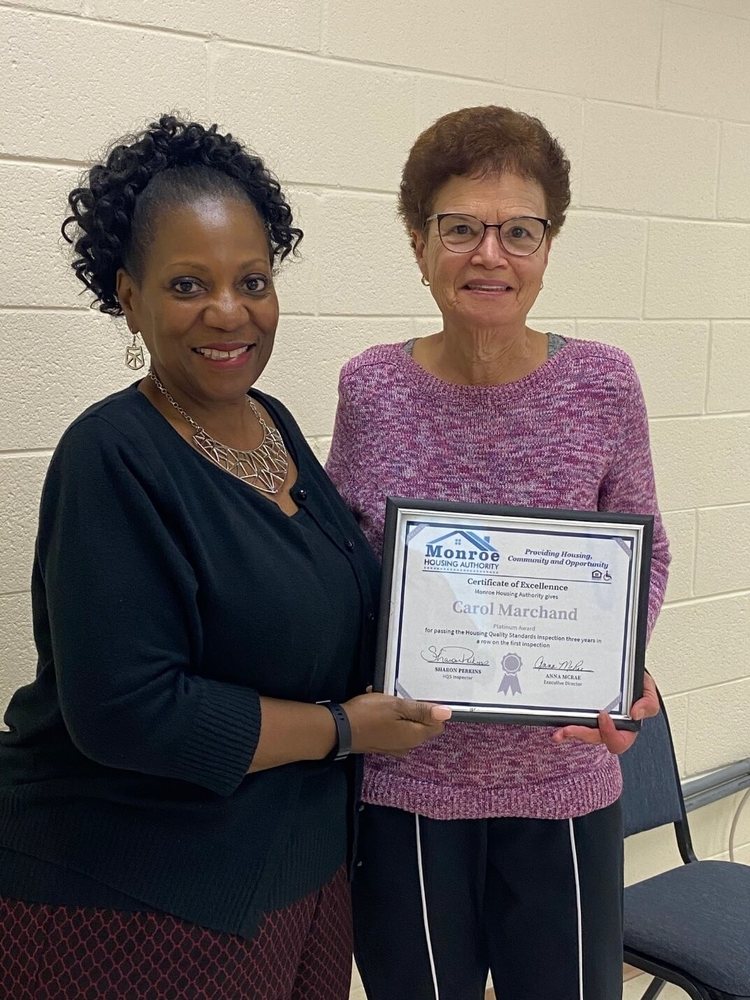 Carol Marchand with platinum certificate of excellence