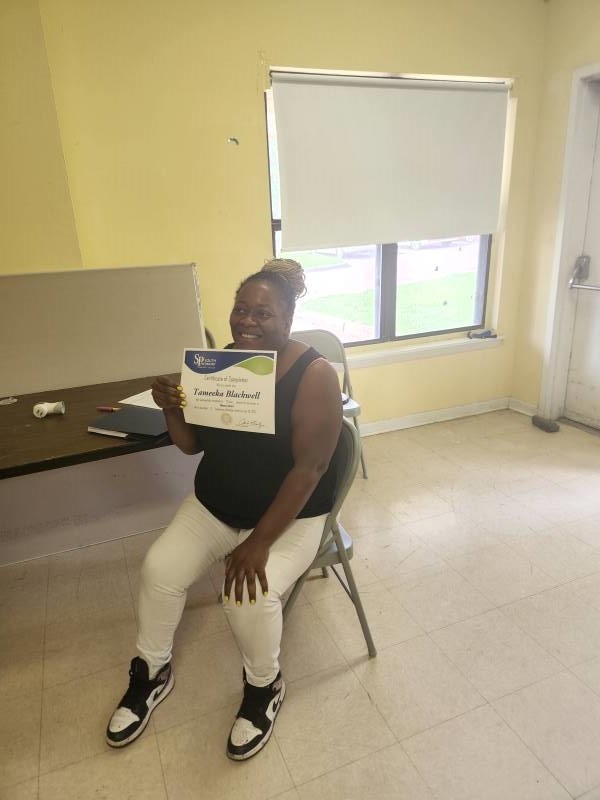 Resident Tameka Blackwell poses with her certificate.