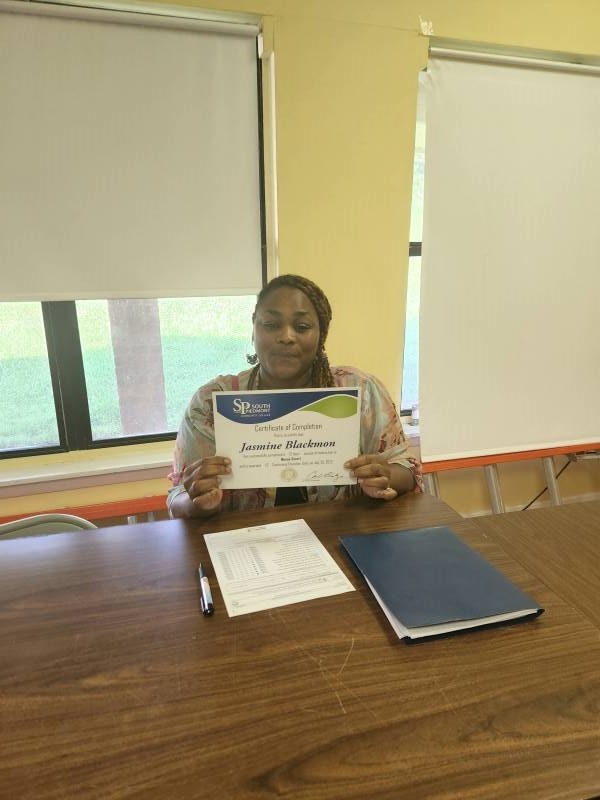 Resident Jasmine Blackmon poses with her certificate.