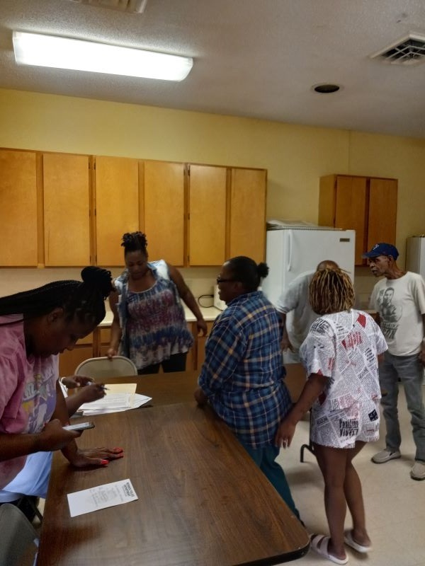 Residents gathering in a meeting room.