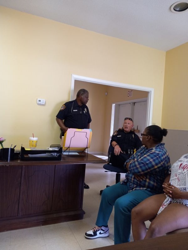 Two residents chatting with police officers.