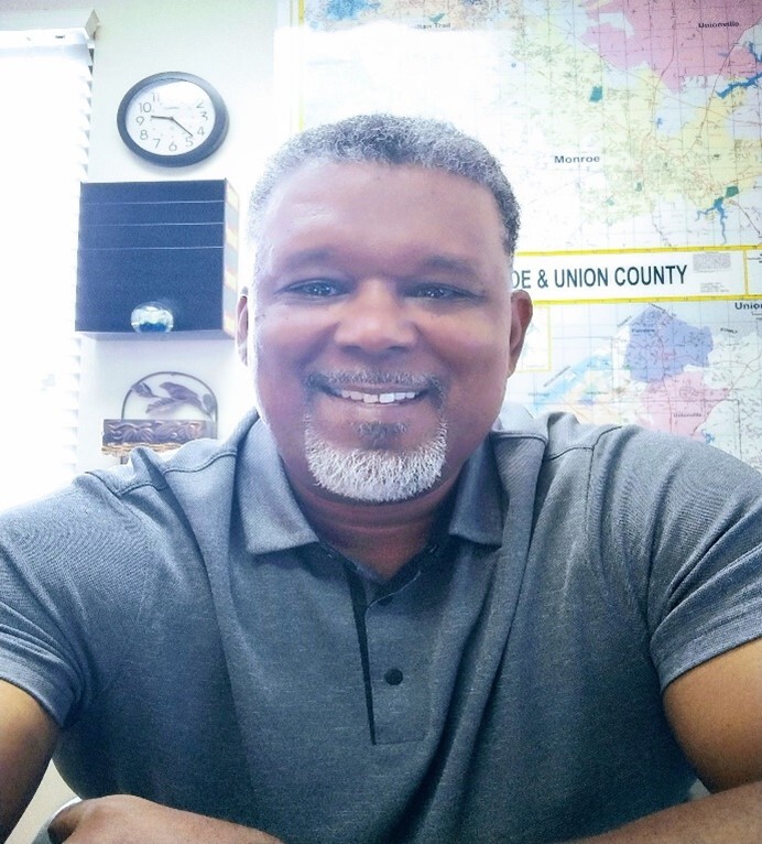 A headshot of a man smiling.