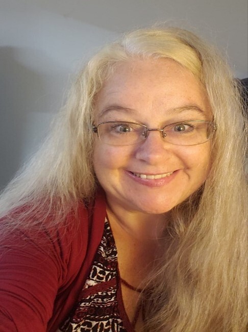 A headshot of a smiling woman. 