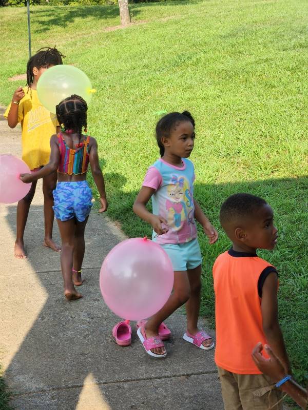 Young kids in line for water balloons.