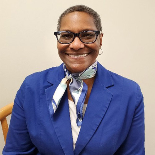 Ms. Benita Sanders smiles a wide smile. 