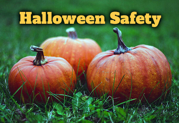 Three pumpkins in a field with the text, Halloween Safety.