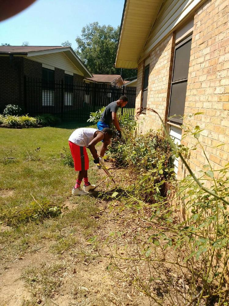 resident youths working on landscaping