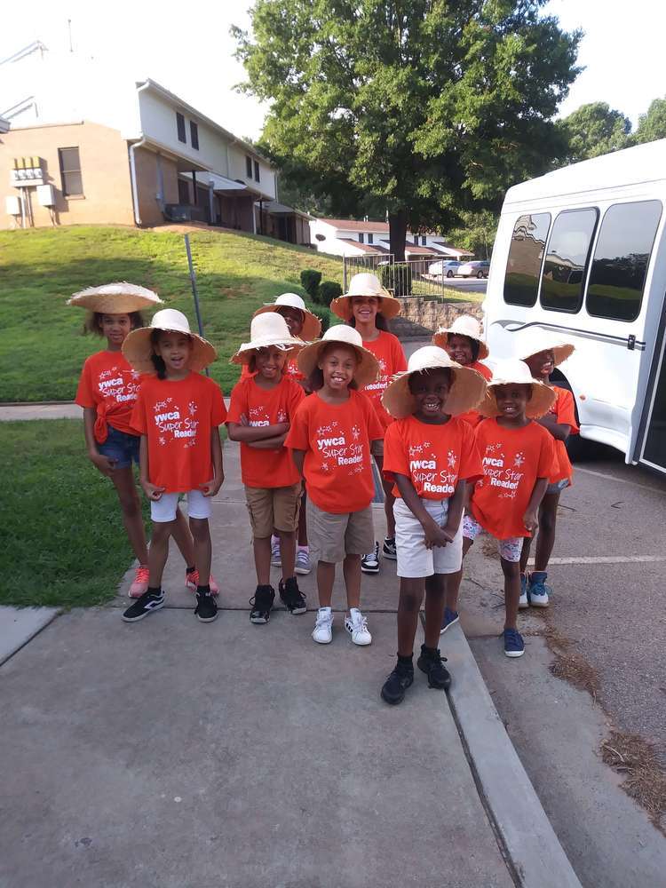 10 YWCA kids with straw hats and orange t-shirts going on field trip