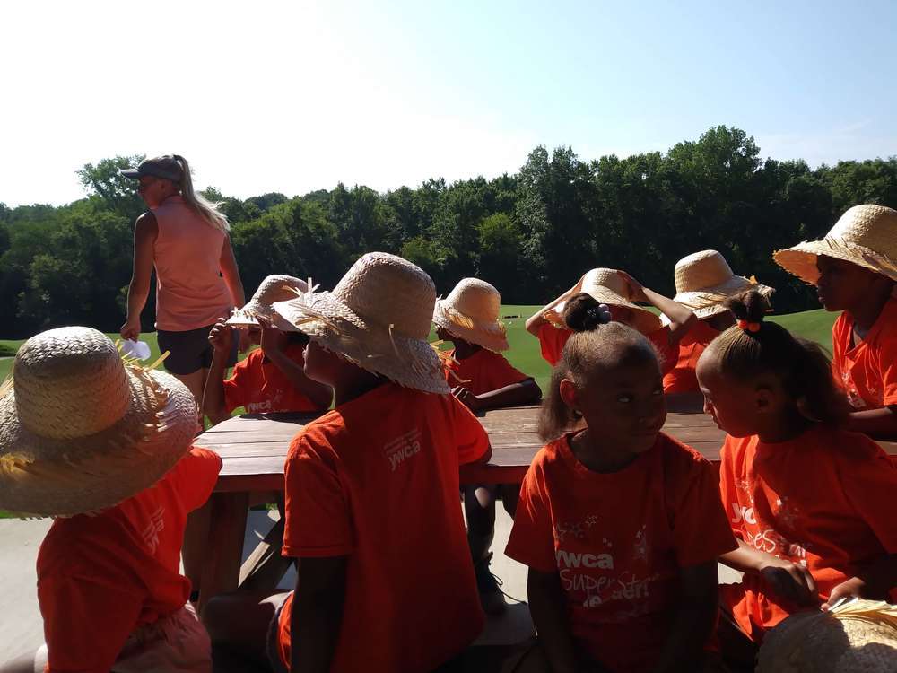 backs of the kids at the field trip sitting at a table