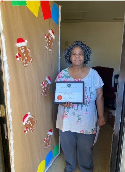 Ms. Patricia Gray with decorated door