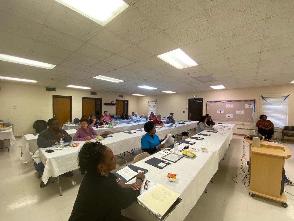 orientation participants seated at tables during presentation