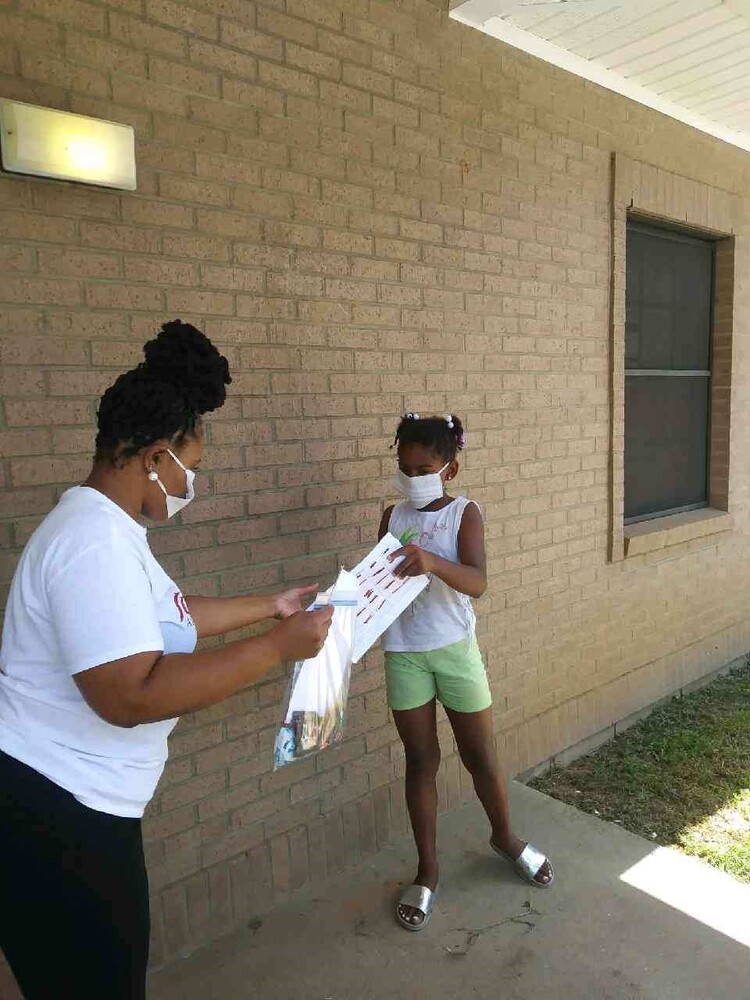 Student receiving packet in exchange for homework