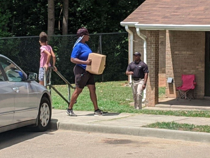 bringing boxes of food to community