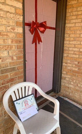 door covered with wrapping paper and a ribbon bow