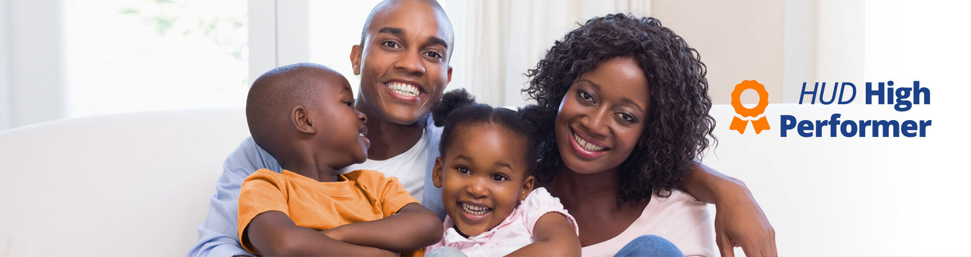 family of four sitting together and smiling