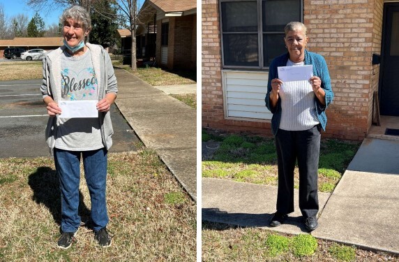 Two residents from the Serenity Place Community posing with their gift cards.