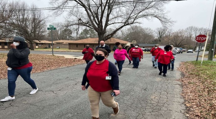Residents walking down the street for the Walking Hearts Event.